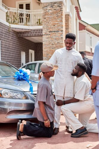 Tearful Woman Kneels Before Moses Bliss in Kenya Amidst Emotional Moment 3 Gospel artiste Moses Bliss surprises mentees with new cars 3